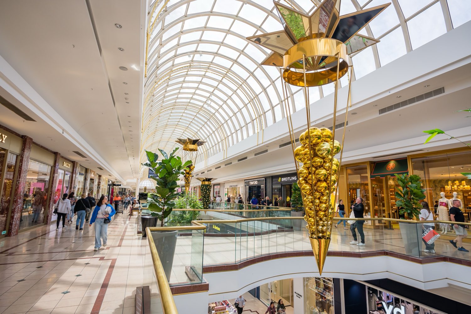 Shoppers in the vaulted glass atrium of an upmarket Australian shopping centre